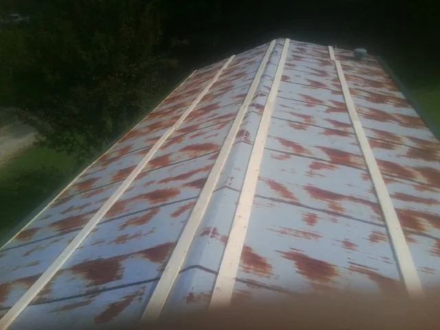 Rusted metal roof panels with new wood purlins before replacement — Storm Damage Roof Repair in Dothan by Roofing Brothers