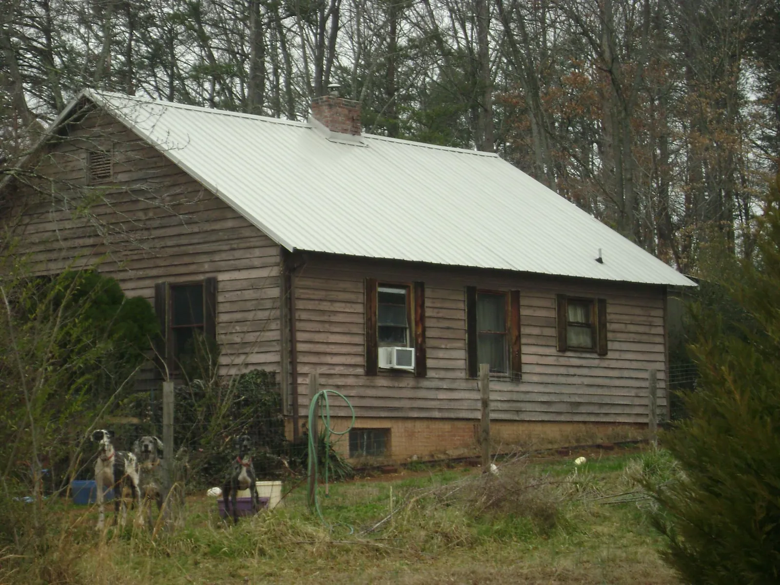 White metal roof on an old wood sided farmhouse, from a Metal Roof Installation job in Dothan